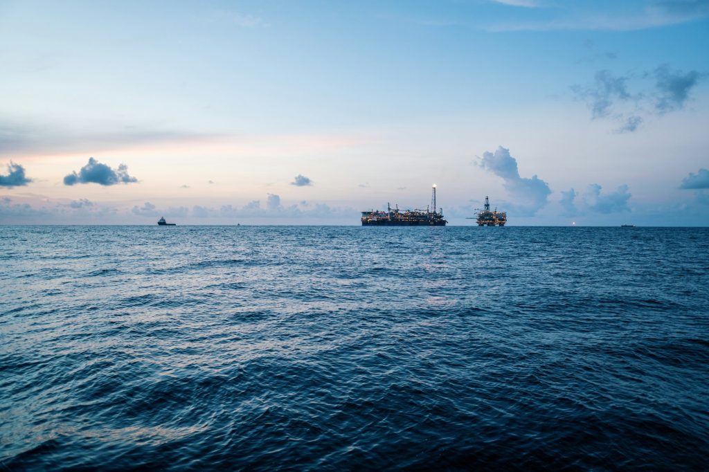 FPSO tanker vessel near Oil Rig platform. Offshore oil and gas industry